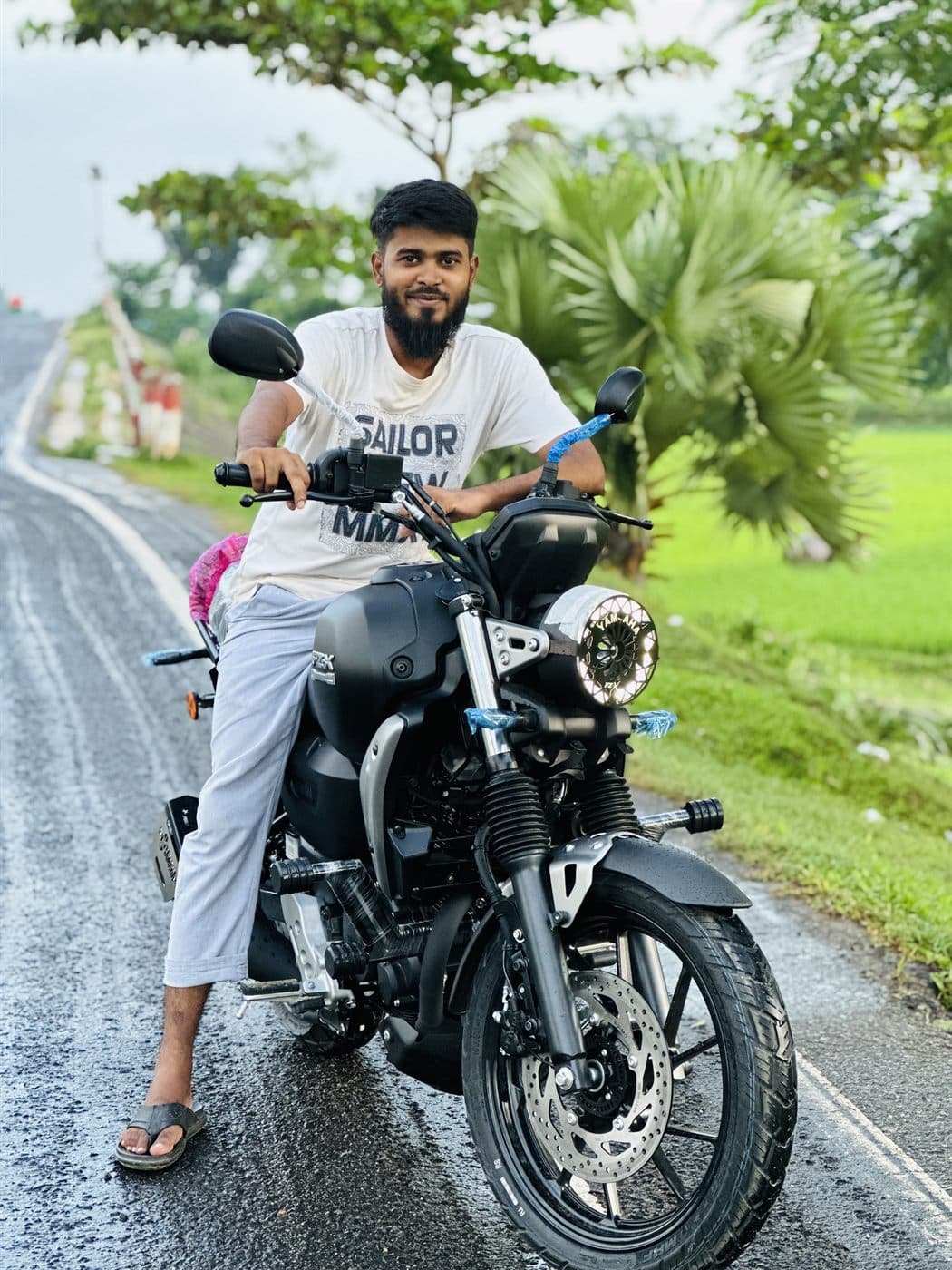 RH Razu with his motorbike on a country road