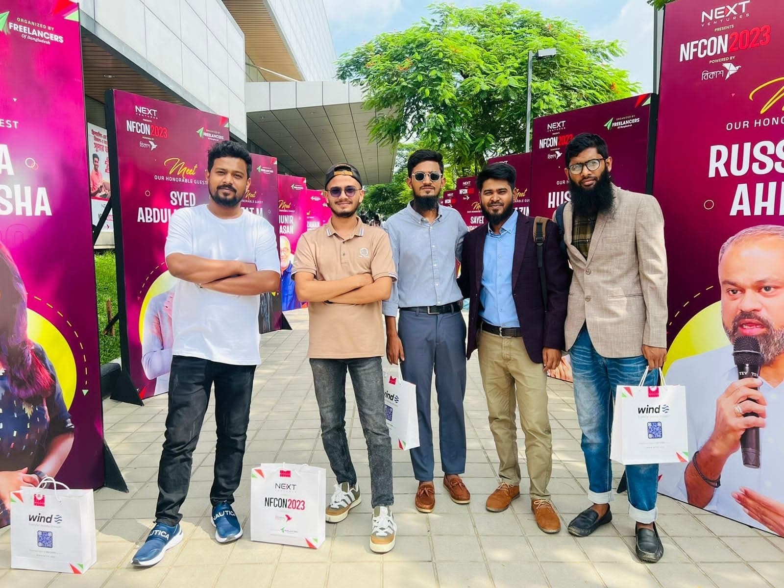 With fellow freelancers between speaker banners at NFCON 2023