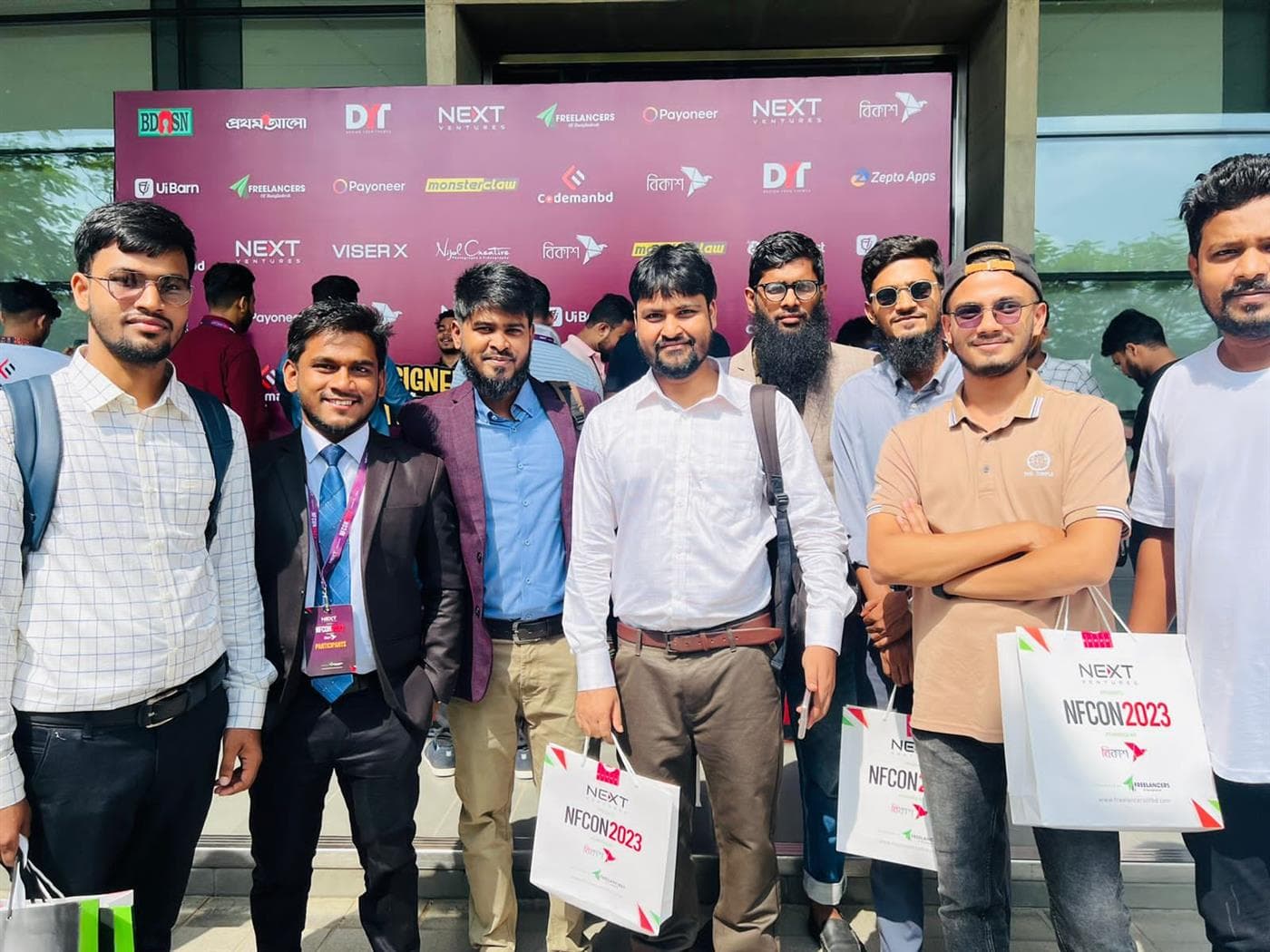 With fellow freelancers at the NFCON 2023 sponsor wall